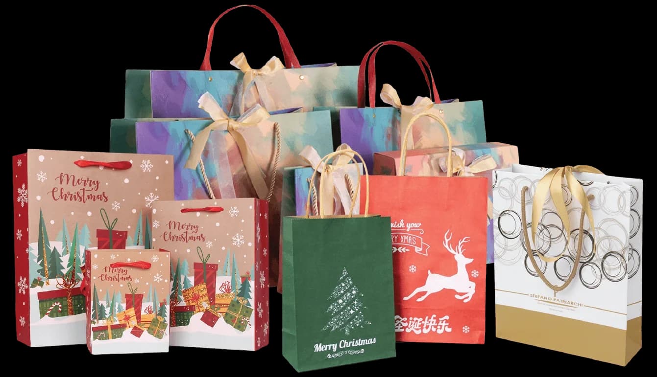 An assortment of custom-printed paper gift bags with ribbon and twisted-rope handles